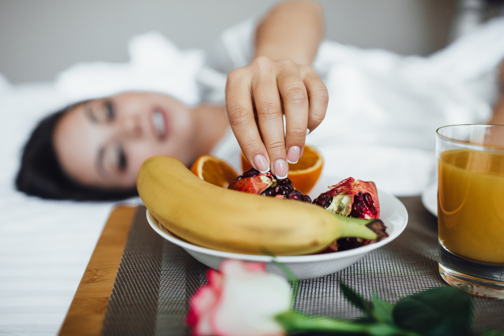 A young woman in the background reaching for some fruits before sleep